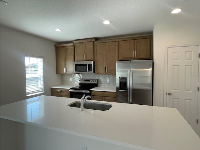 kitchen with tasteful backsplash, stainless steel appliances, and sink