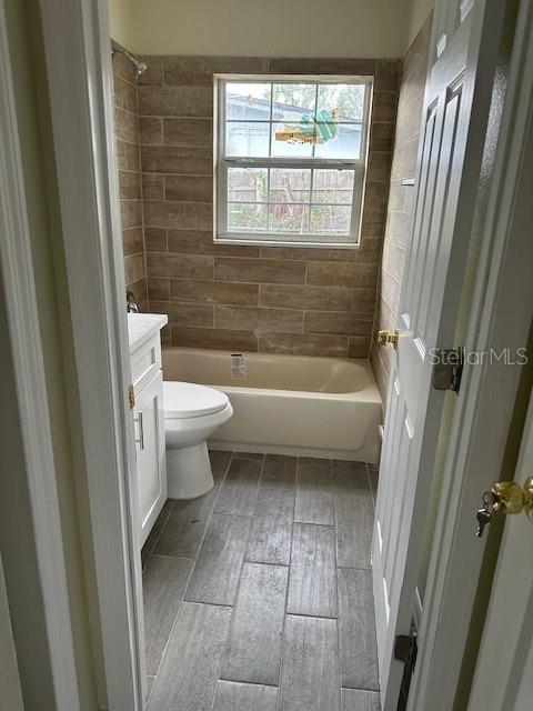 full bathroom with toilet, bathtub / shower combination, and vanity