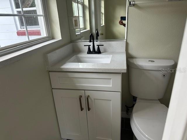 bathroom with vanity and toilet