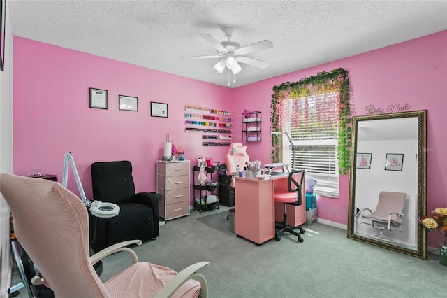 office area featuring a textured ceiling, a ceiling fan, and light colored carpet