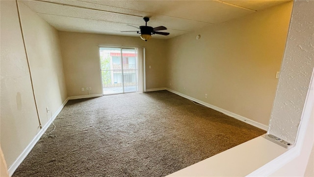 carpeted spare room featuring ceiling fan