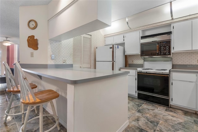 kitchen with kitchen peninsula, a breakfast bar, range with electric stovetop, white refrigerator, and white cabinets