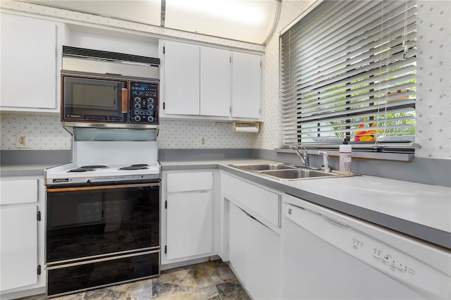 kitchen featuring sink, range with electric cooktop, white cabinets, and white dishwasher