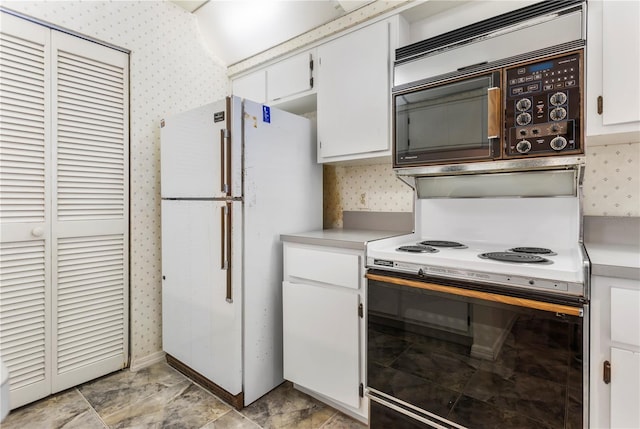 kitchen with white appliances and white cabinets