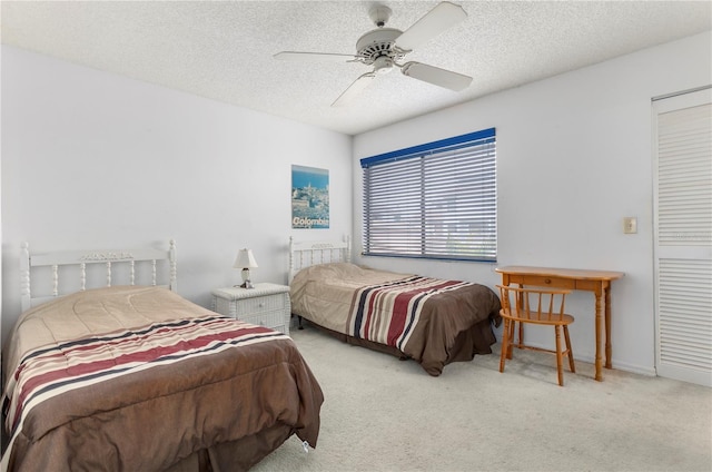 carpeted bedroom with a textured ceiling and ceiling fan