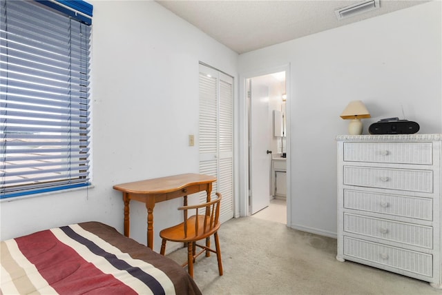 carpeted bedroom featuring connected bathroom