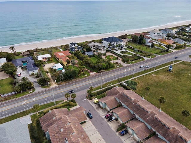 birds eye view of property with a beach view and a water view