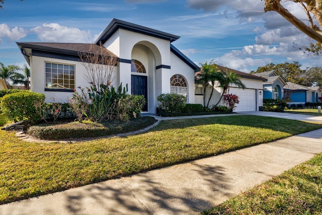 view of front of property featuring a garage, a front lawn, concrete driveway, and stucco siding