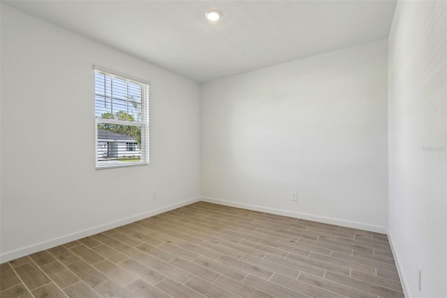 empty room featuring baseboards and wood finished floors