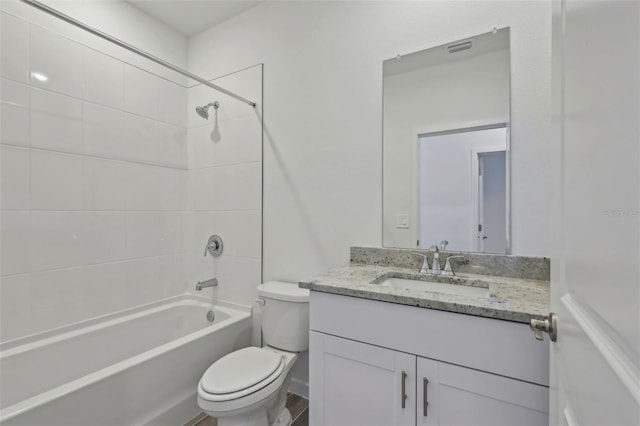 full bath with toilet, vanity, visible vents, and bathing tub / shower combination