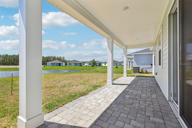 view of patio with a porch, a residential view, and a water view