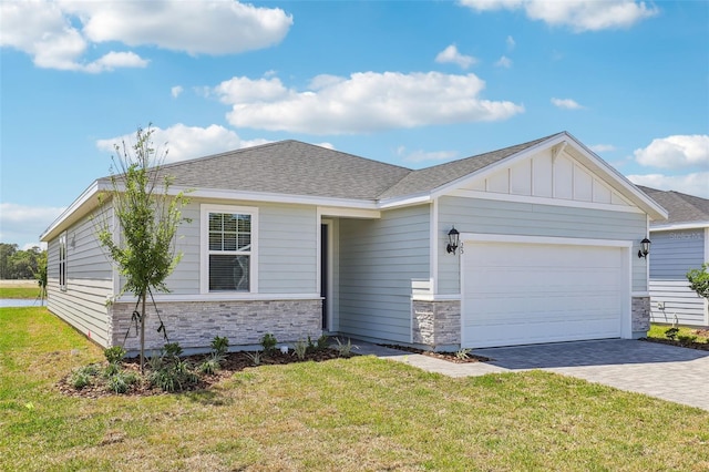 view of front facade featuring a garage, board and batten siding, a front lawn, and decorative driveway