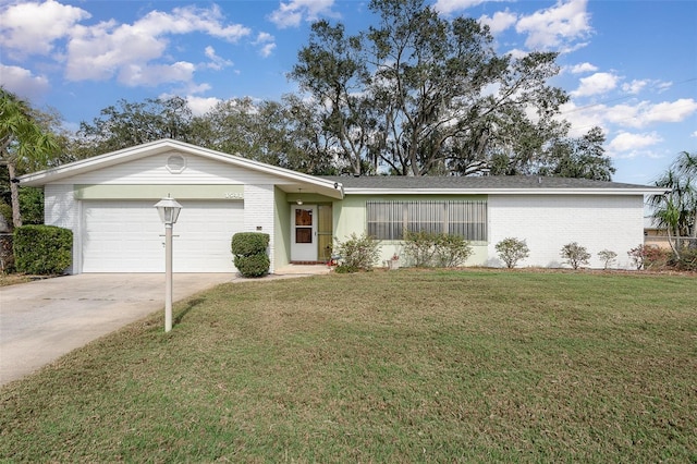 single story home featuring a garage and a front lawn