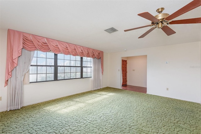 unfurnished room with carpet floors and ceiling fan