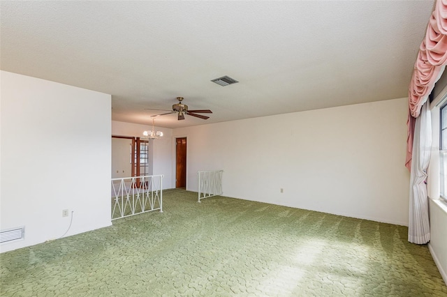 unfurnished room featuring carpet floors, ceiling fan with notable chandelier, and a textured ceiling