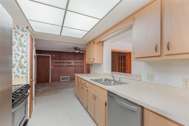 kitchen with appliances with stainless steel finishes, sink, and light brown cabinets