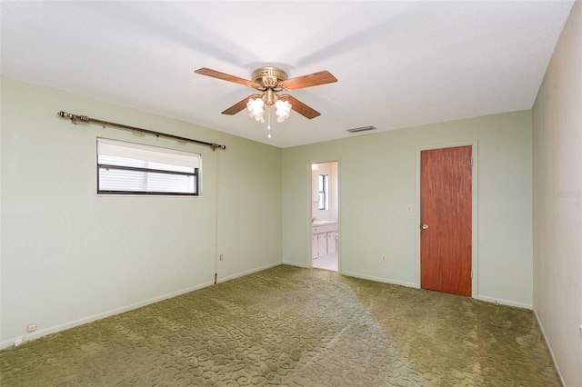 spare room featuring ceiling fan and carpet