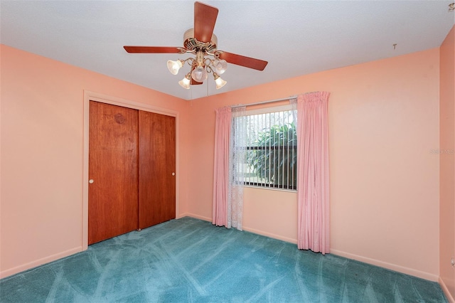 unfurnished bedroom with ceiling fan, carpet floors, and a closet