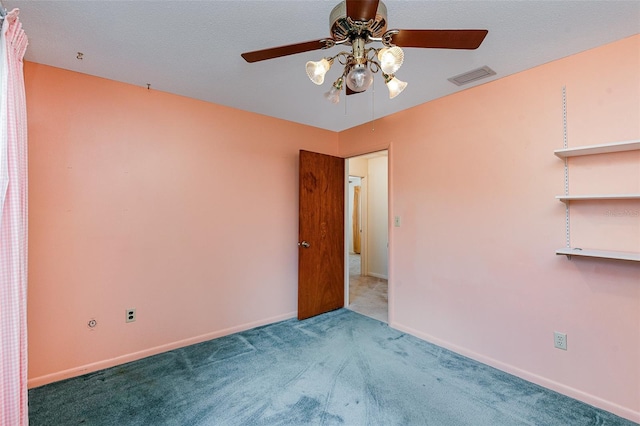 empty room with ceiling fan and carpet