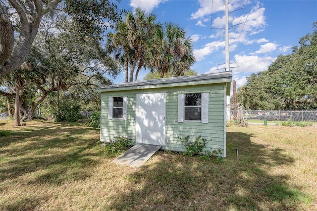 view of outbuilding with a yard