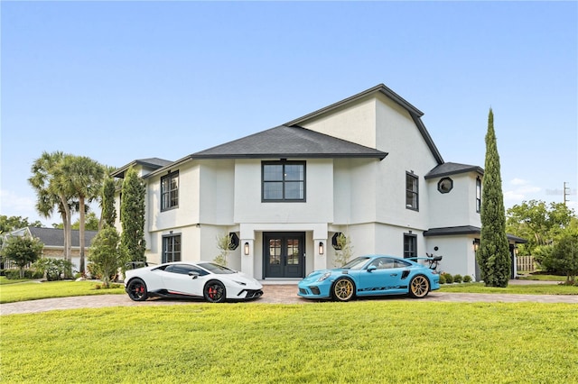 view of front of home with french doors and a front lawn