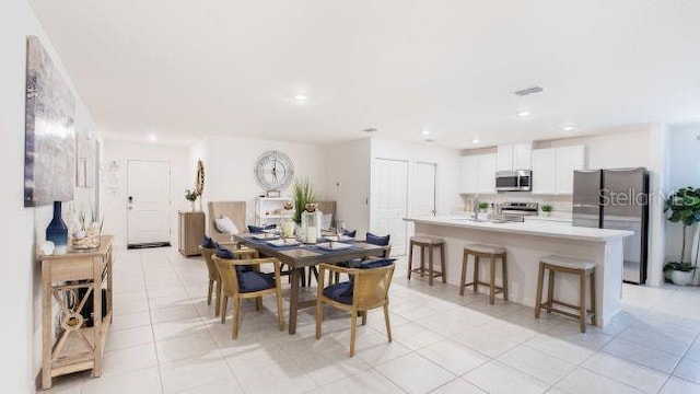 dining space featuring light tile patterned flooring