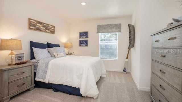 bedroom featuring light carpet