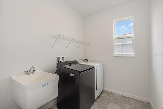 washroom with sink and washing machine and dryer