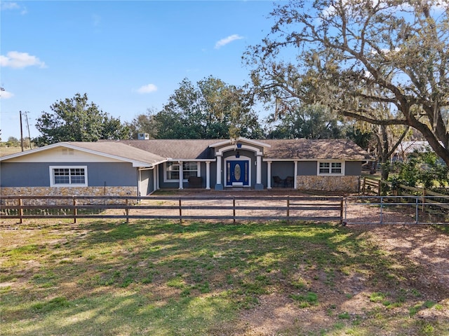 37224 Apiary Rd, Grand Island, FL 32735 - ranch-style house with a fenced front yard, stucco siding, a garage, and stone siding