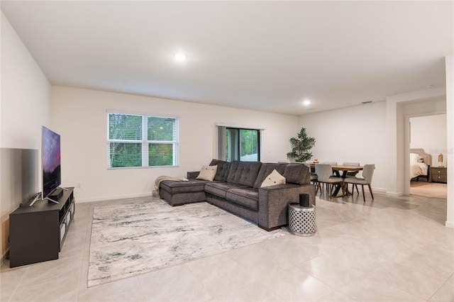 living area with recessed lighting and baseboards