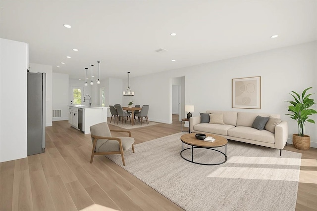 living area featuring light wood-type flooring, recessed lighting, and baseboards