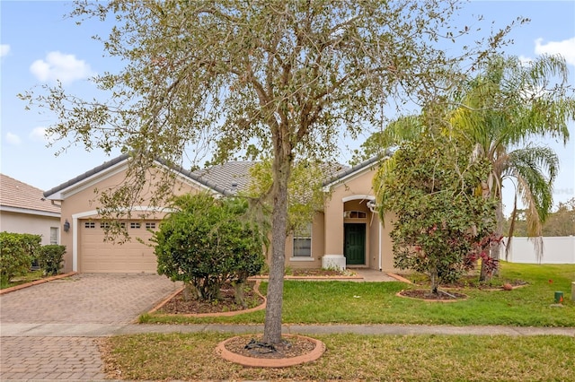 view of front of home featuring a garage and a front lawn