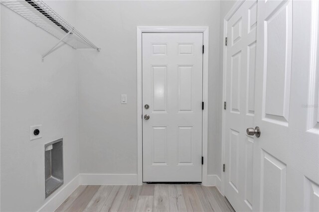 2844 SW 162nd Street Rd, Ocala, FL 34473 - laundry area with light hardwood / wood-style flooring and electric dryer hookup