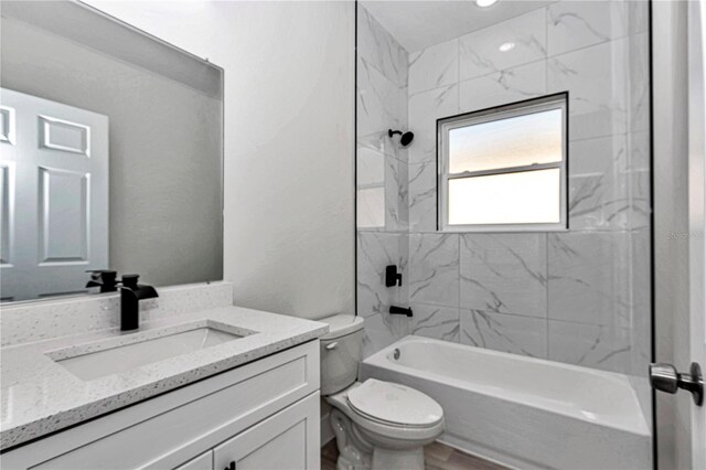 2844 SW 162nd Street Rd, Ocala, FL 34473 - full bathroom featuring tiled shower / bath, vanity, and toilet