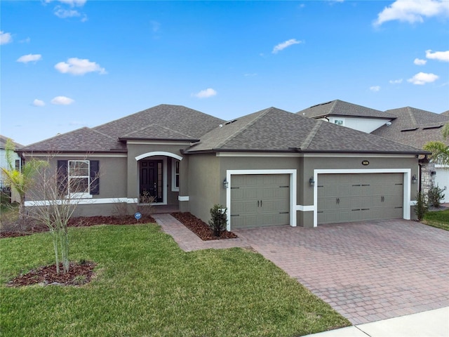 view of front of property featuring a garage and a front yard