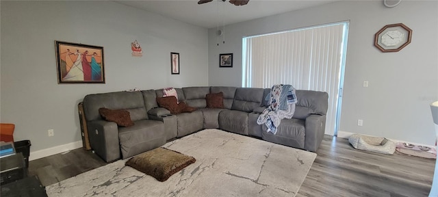 living room with hardwood / wood-style floors and ceiling fan