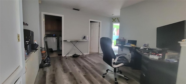 office space featuring washer / clothes dryer and hardwood / wood-style flooring