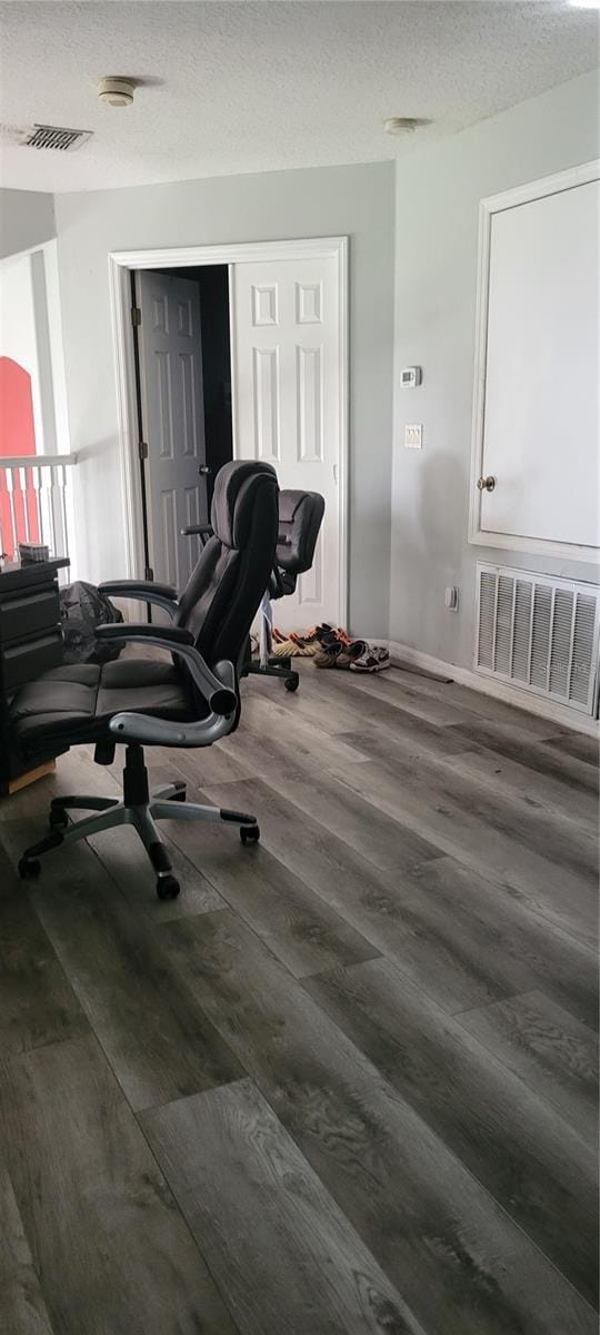 office featuring dark hardwood / wood-style flooring and a textured ceiling