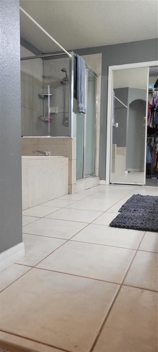 bathroom featuring tile patterned floors and an enclosed shower
