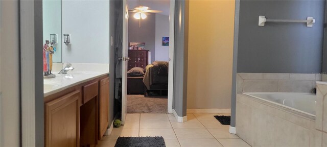 bathroom with ceiling fan, vanity, tiled bath, and tile patterned flooring
