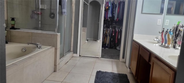 bathroom featuring vanity, independent shower and bath, and tile patterned flooring