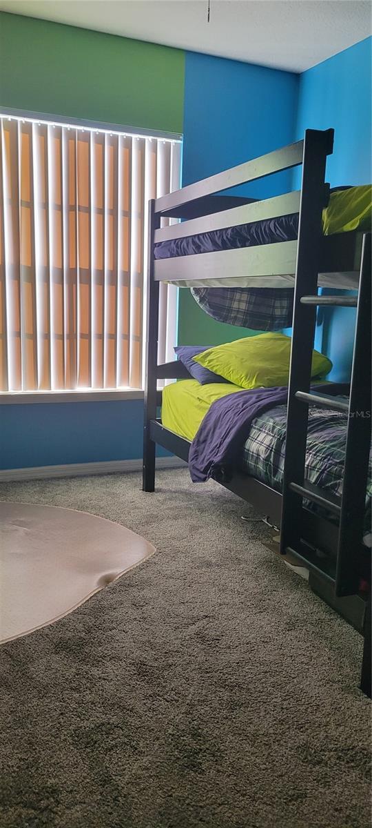 unfurnished bedroom with carpet floors