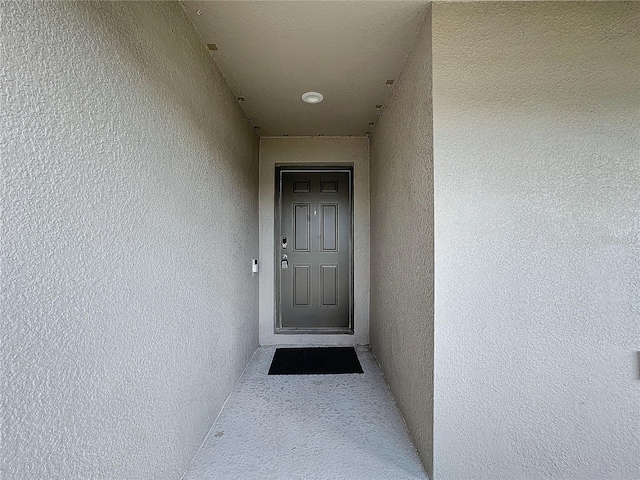 doorway to property with stucco siding