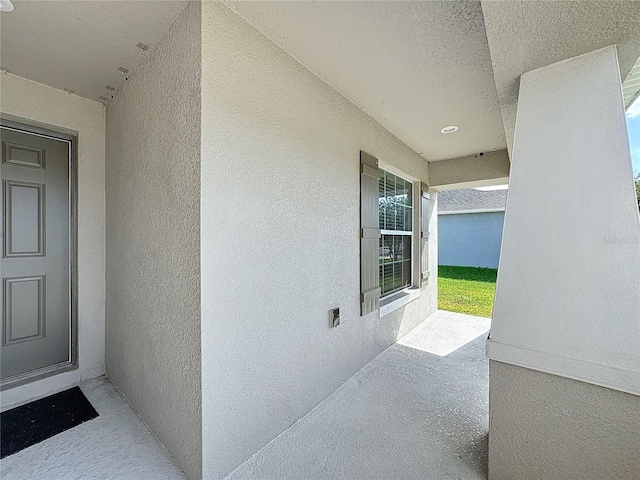 view of exterior entry with stucco siding