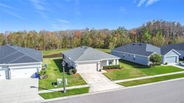 birds eye view of property featuring a view of trees