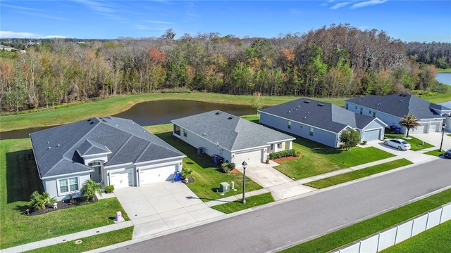 birds eye view of property with a forest view and a water view