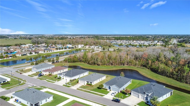 birds eye view of property with a residential view and a water view