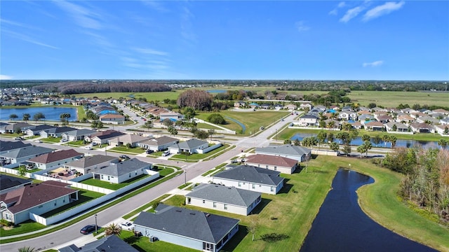 drone / aerial view with a residential view and a water view