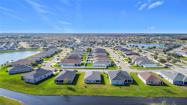 drone / aerial view featuring a residential view and a water view