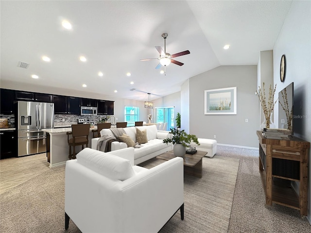 living area with a ceiling fan, visible vents, baseboards, lofted ceiling, and recessed lighting